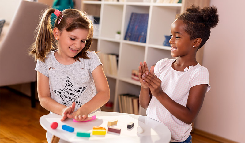 Children playing with colorful plasticine